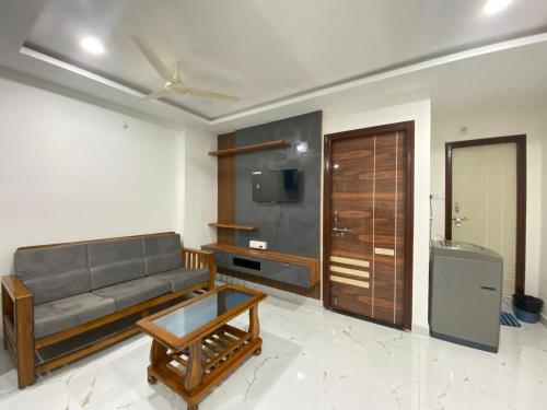 a living room with a couch and a table at Millennia service apartments in Hyderabad