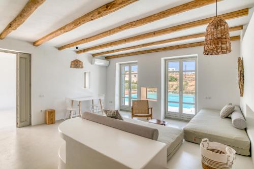 a living room with a couch and a table at Lil Paros Luxury suites in Dhragoulás