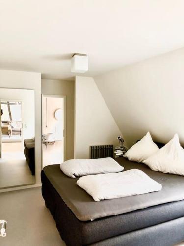 a bedroom with two beds and a mirror at Wohnen direkt am Moselstrand in Bernkastel-Kues