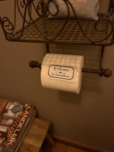 a roll of toilet paper is hanging on a shelf at Prachtige vakantiewoning met weids uitzicht in Maldegem