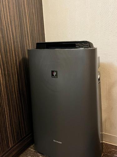 een zwarte koelkast naast een muur bij Smile Hotel Asakusa - Vacation STAY 71442v in Tokyo