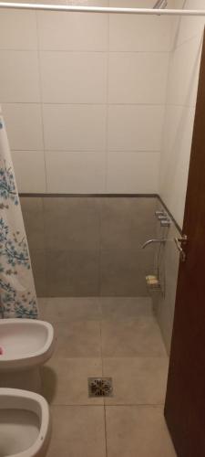 a bathroom with a toilet and a sink in it at Casa quinta Las Juana in Paraná