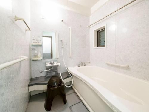 a white bathroom with a tub and a sink at Takinomoto Kondo family - Vacation STAY 30830v in Toon