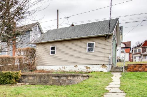 a white house with a gray roof on a yard at Family-Friendly Altoona Abode with Spacious Patio! in Altoona