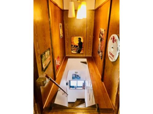 a hallway with a person sitting in a mirror at Showa No Toraya - Vacation STAY 61518v in Chikuma