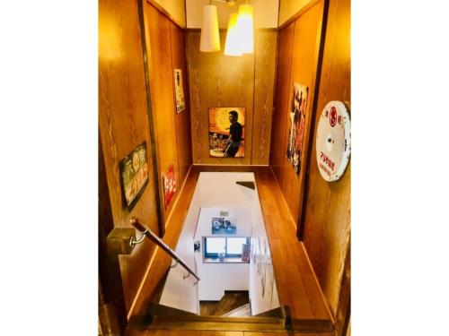 a hallway with a person sitting in a mirror at Showa No Toraya - Vacation STAY 61491v in Chikuma