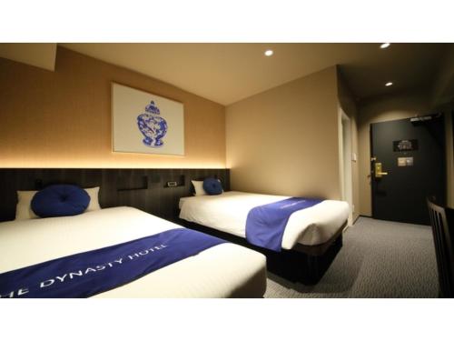 2 camas en una habitación de hotel con 2 camas en Dynasty Hotel Osaka - Vacation STAY 61768v, en Osaka