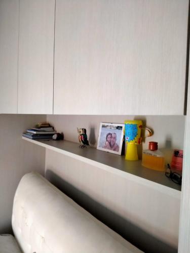 a shelf with some toys and pictures on it at Appartamenti Centro Seriate in Seriate