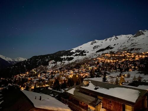a view of a town in the snow at night at Chalet Alexandre in Verbier