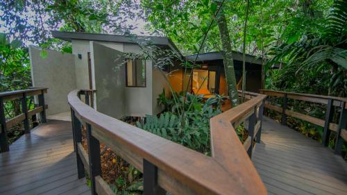 a wooden deck with a wooden fence and plants at Chachagua Rainforest Hotel & Hot Springs in Fortuna