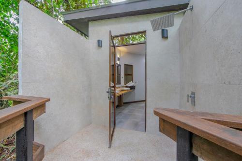 an open door to the bathroom of a house at Chachagua Rainforest Hotel & Hot Springs in Fortuna