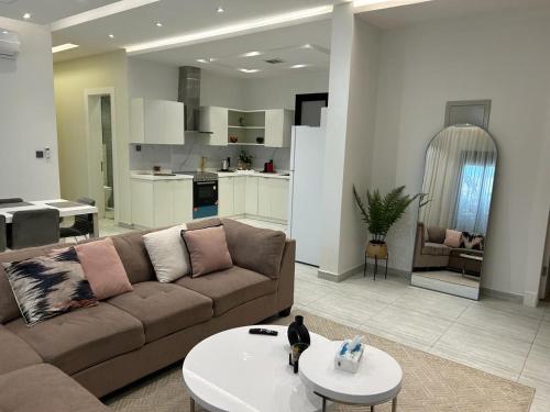 a large living room with a couch and a table at Smart luxury apartment 3bedrooms in Riyadh