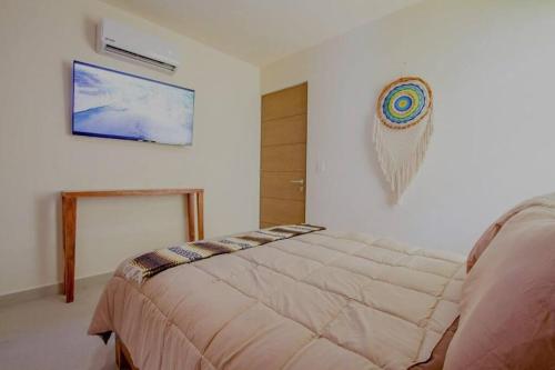 a bedroom with a bed and a picture on the wall at Akumal Heaven Beach Access 7 Rooftop Pools W Caribbean Sea Views + Beach Club in Akumal