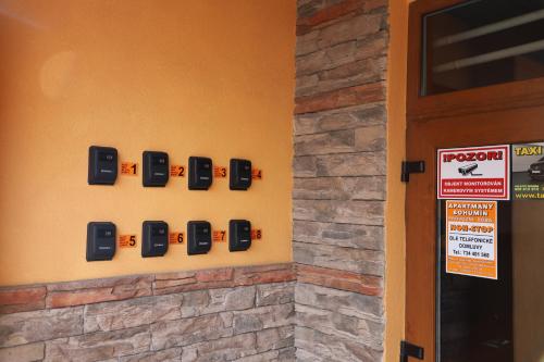 a wall with a row of alarm clocks on a wall at Kolík Apartmány in Bohumín