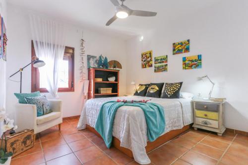a bedroom with a bed and a chair at Let´s go to Valhalla in Chiclana de la Frontera