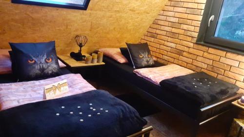 a room with two twin beds withooky faces on them at Zaciszny Zakątek Zawoja in Zawoja