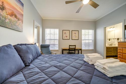 a bedroom with a blue bed with a ceiling fan at Lakeside Cashiers Cabin with Private Boat Dock! in Cullowhee