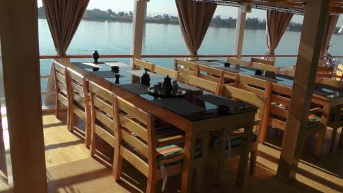 a dining room with a view of the water at Ben's Dahabeya in Aswan
