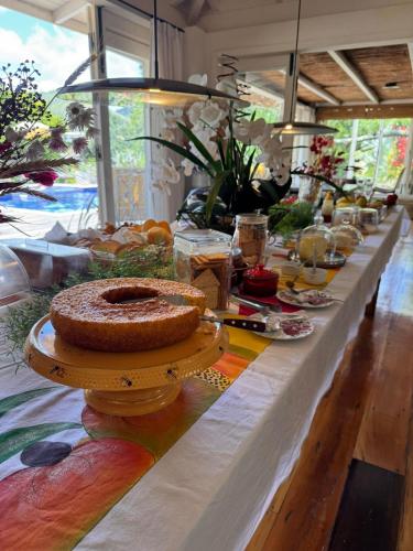 a long table with a cake on top of it at Pousada Boutique Itaipava in Itaipava