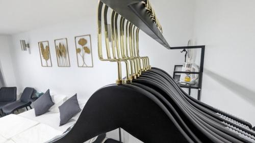 a black and gold hammock in a room with a couch at Chu-Cha's Rooms in Koh Samui 