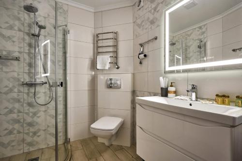 a bathroom with a toilet and a sink and a shower at Zaporizʹka Sich in Bukovel