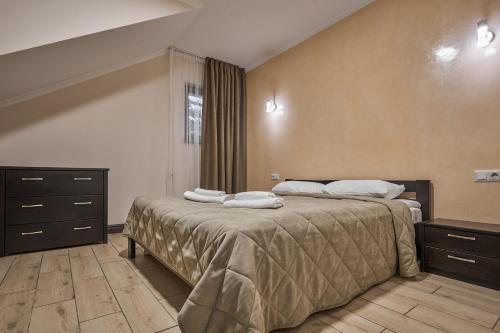 a bedroom with two beds with towels on them at Zaporizʹka Sich in Bukovel