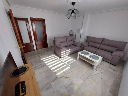 a living room with a couch and a table at El Patio de Lola in Córdoba