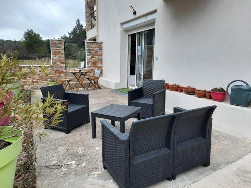 a patio with two chairs and a table at Location venelles in Venelles