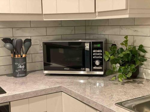 a microwave oven sitting on a counter in a kitchen at Modern family home in Castleisland