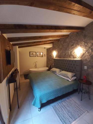 a bedroom with a bed and a bath tub at Maria Blanca in Santeagueda