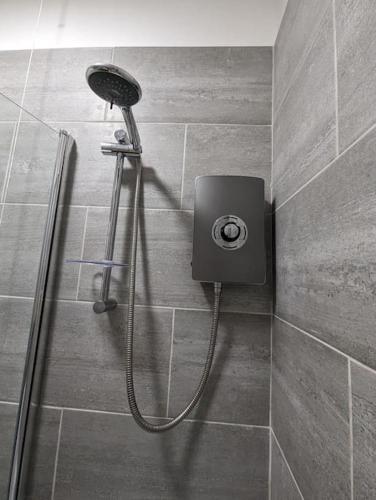 a shower with a shower head in a bathroom at 3-bed Home For Football Fans in Liverpool