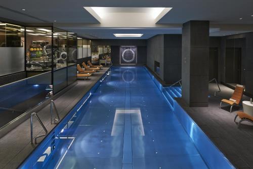 a large swimming pool with a blue floor at Mandarin Oriental Hyde Park, London in London