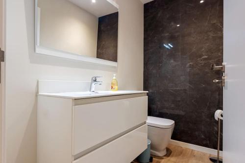 a bathroom with a sink and a toilet at Luxury and modern apartment in Porto Moniz center in Porto Moniz