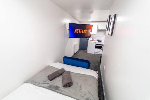 a small room with a bed and a television at Captivating 1-Bed Studio in Birmingham in Birmingham