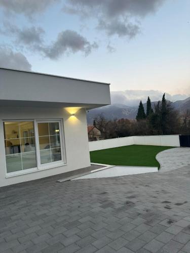 a white house with a view of the mountains at Villa Aria in Mostar