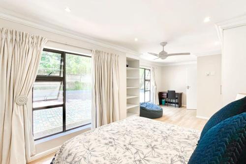 a bedroom with a bed and a large window at Luxurious, spacious & central in Sandton