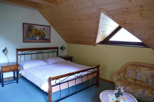 a bedroom with a large bed and a window at Chata Šafran in Liptovský Ján