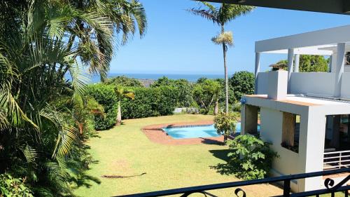 a view of the backyard of a house with a swimming pool at Stylish Loft Style Apartment in Durban