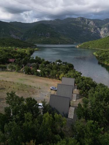 arial view of a river with trees and a body of water at Agora Farmhouse in Koman