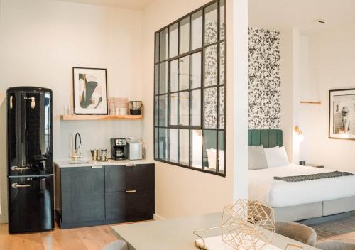 a living room with a bed and a refrigerator at Reunion Hotel in Nashville