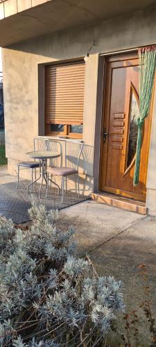 a patio with a table and chairs in front of a door at Studio Apartman Ana Doboj in Doboj