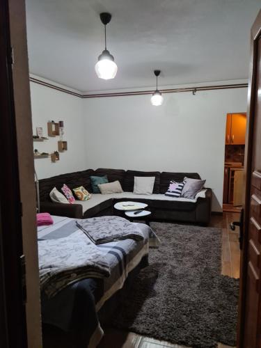 a living room with two beds and a couch at Studio Apartman Ana Doboj in Doboj