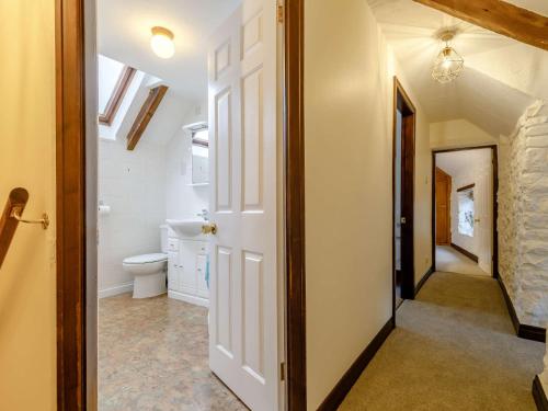 a hallway with a bathroom with a toilet and a window at 4 Bed in Brassington 85450 in Brassington