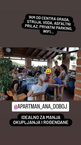 a group of people sitting at tables at a party at Studio Apartman Ana Doboj in Doboj
