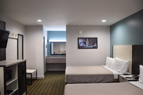 a hotel room with two beds and a television at SureStay by Best Western Huntsville University Area in Huntsville