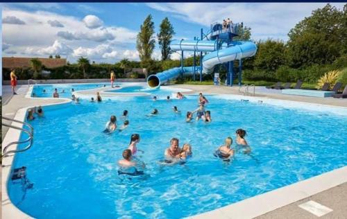 a group of people in a swimming pool at 8Berth- SmartTV- CloseToBeach- FamilyFriendly in Mablethorpe