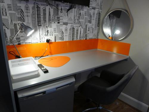 a desk with a computer and a chair and a mirror at Saltoun House in Fraserburgh