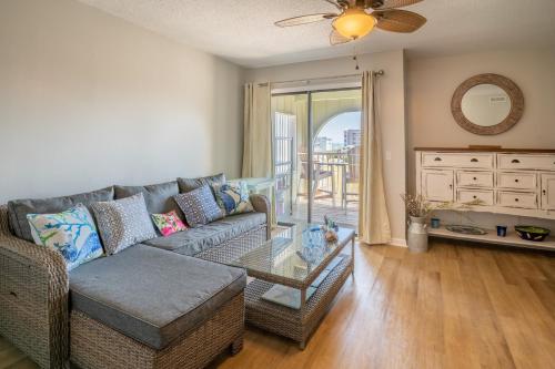 a living room with a couch and a glass table at Condo in the heart of Downtown Carolina Beach in Carolina Beach