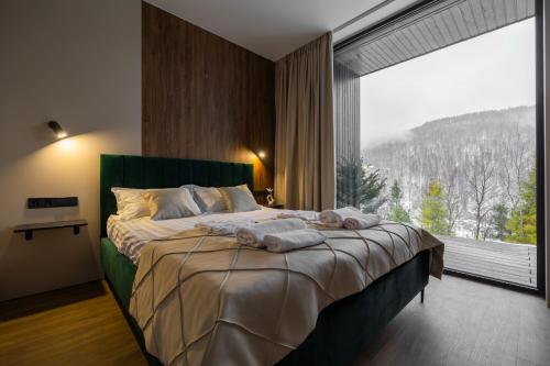 a bedroom with a large bed with a large window at PROSTIR in Korostov