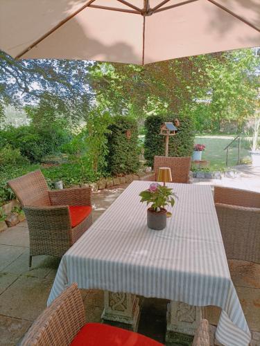 a table and chairs with a table and an umbrella at Haus Tourneur in Lippetal